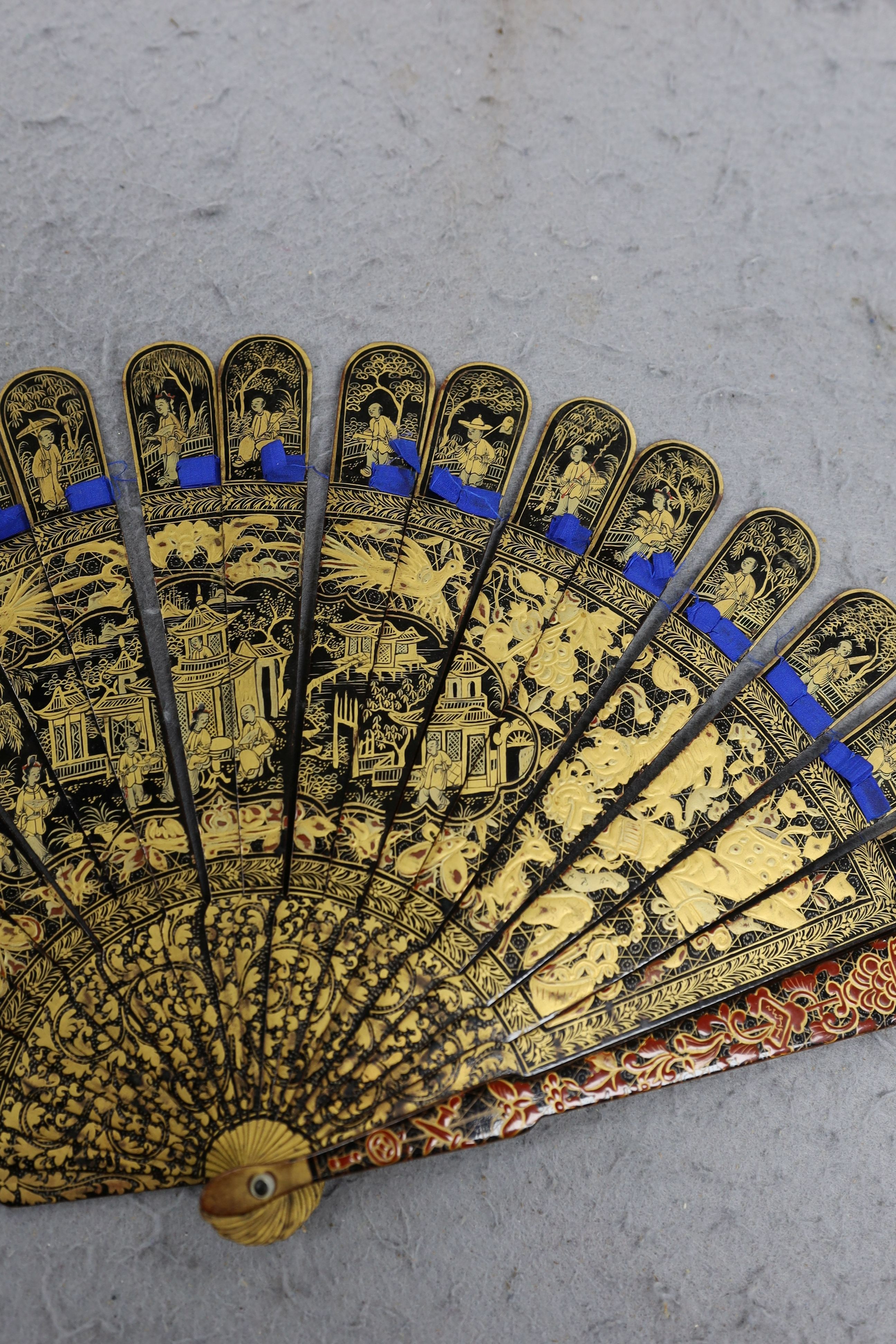 A Chinese gilt-decorated lacquer fan in a brocade covered case, 19th century